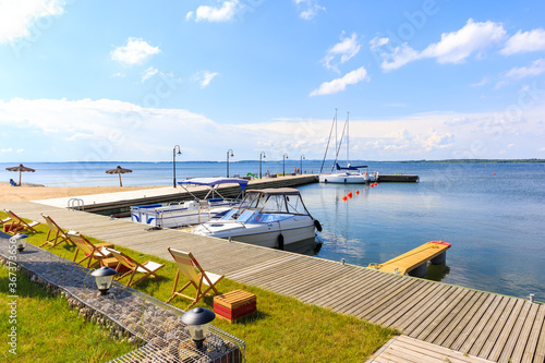 Yacht boats at pier in sailing port Nowe Guty on Lake Sniardwy on summer sunn...