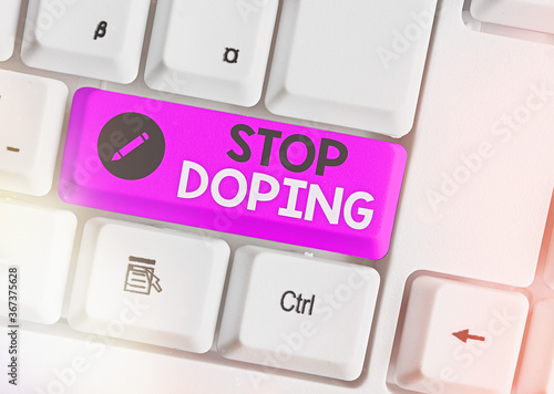 Text sign showing Stop Doping. Business photo text quit the use of banned athletic performanceenhancing drugs Different colored keyboard key with accessories arranged on empty copy space photo