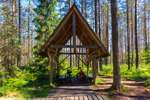 Bicycles parked in small shed for tourists among swamp area in green forest near Nowy Targ town, Podhale region, Poland © pkazmierczak