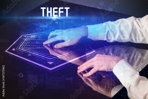 Hand touching digital table with THEFT inscription, new age security concept