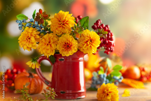 Leinwand Poster Autumn floral still life with beautiful yellow dahlia in vintage red jug and pumpkins on the table