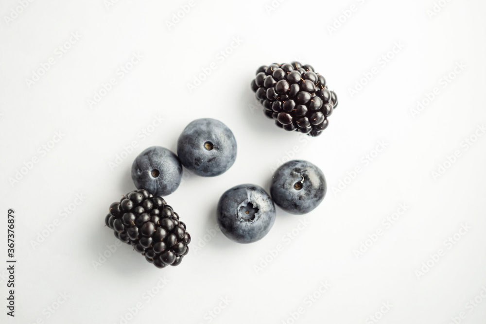 Blackberries and blueberries on white Blackberries and blueberries on white