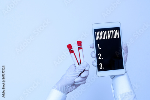 Handwriting text writing Innovation. Conceptual photo the application of better solutions that meet new requirements Extracted blood sample vial with lastest technology ready for examination photo