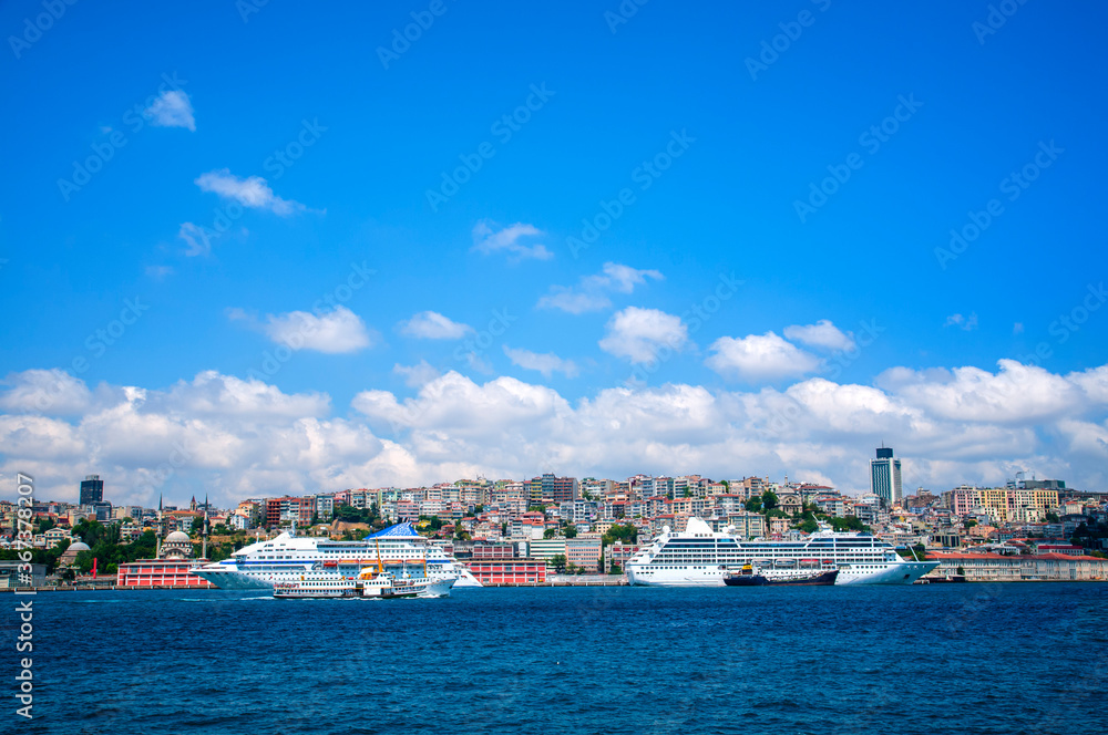 Luxury cruise ship in Bosporus against galata tower, Istanbul.