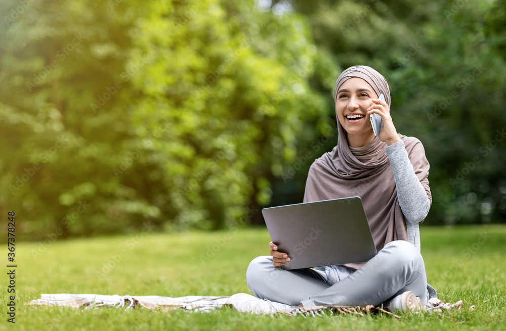 Positive arab girl freelancer working at park Positive arab girl freelancer working at park
