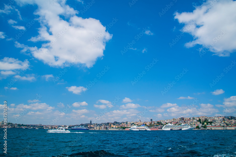 Luxury cruise ship in Bosporus against galata tower, Istanbul.