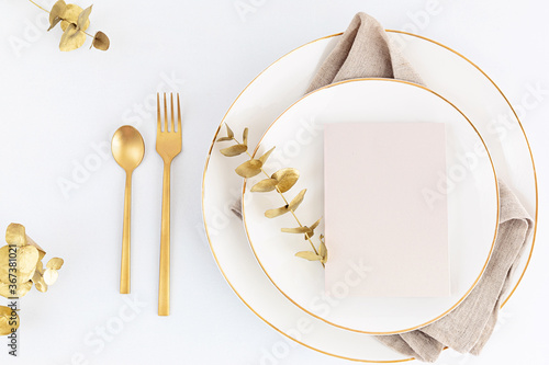 Billede på lærred Festive christmas, wedding, birthday table setting with golden cutlery and porcelain plate