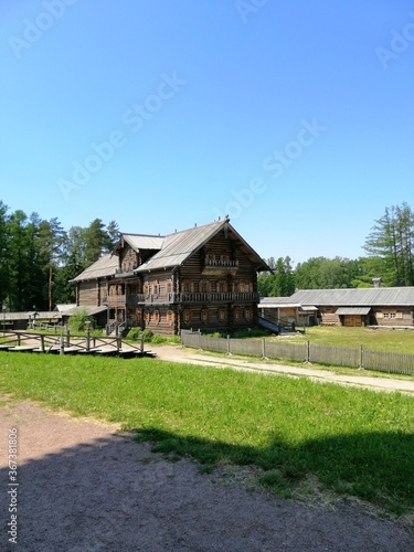 Saint-Petersburg,Russia-07.18.2020: The wooden buildings in the Bogoslovka Estate park ensemble in Saint-Petersburg.The church of the holy virgin photo