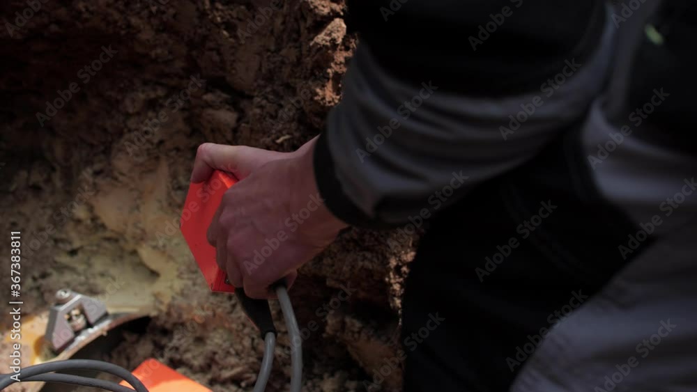 employee connects red box to exact seismographical sensor employee connects red box to exact seismographical sensor