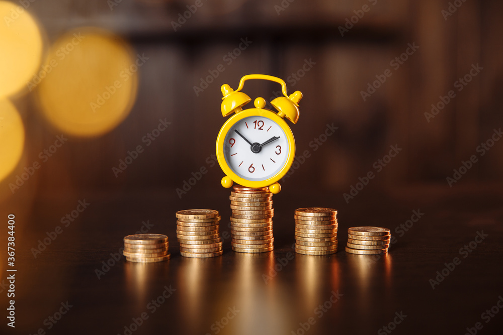 Yellow alarm clock and stack of coins with financial concept. Yellow alarm clock and stack of coins with financial concept.