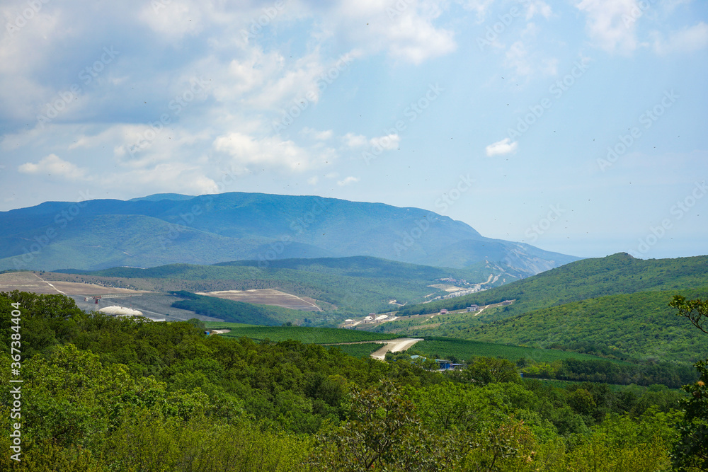 beautiful view of the valley with vineyards and mountains on a hot summer sunny day. Black sea coast near the Anapa resort.