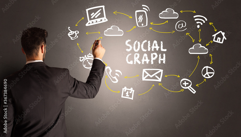 businessman drawing social media icons with SOCIAL GRAPH inscription, new media concept