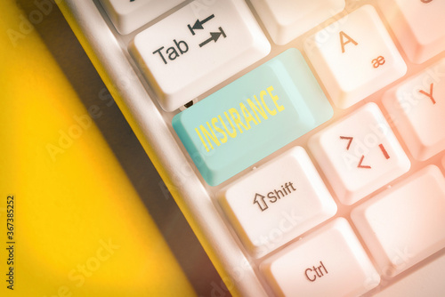 Word writing text Insurance. Business photo showcasing coverage by contract whereby one party undertakes to guarantee Different colored keyboard key with accessories arranged on empty copy space photo
