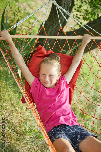 Summer vacation - lovely girl in wicker hammock