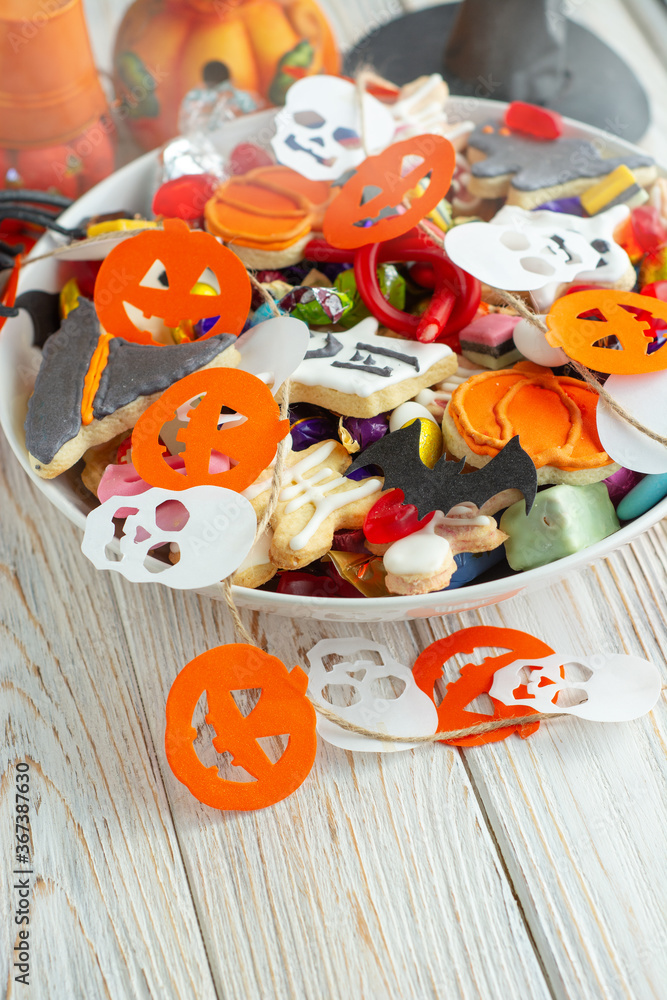 Halloween Jack o Lantern candy bowl with candy and halloween cookies Trick or Treat on white background