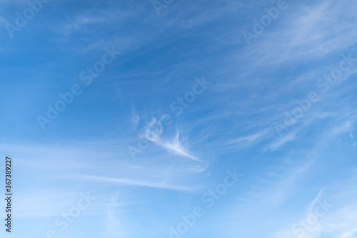 Photography Blue sky with whispy cirrus clouds streaking past