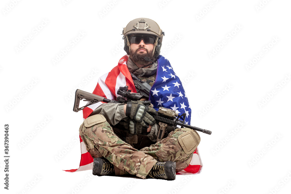 Fototapeta premium american soldier in uniform with usa flag sits on white background, ranger with military ammunition, hero of america