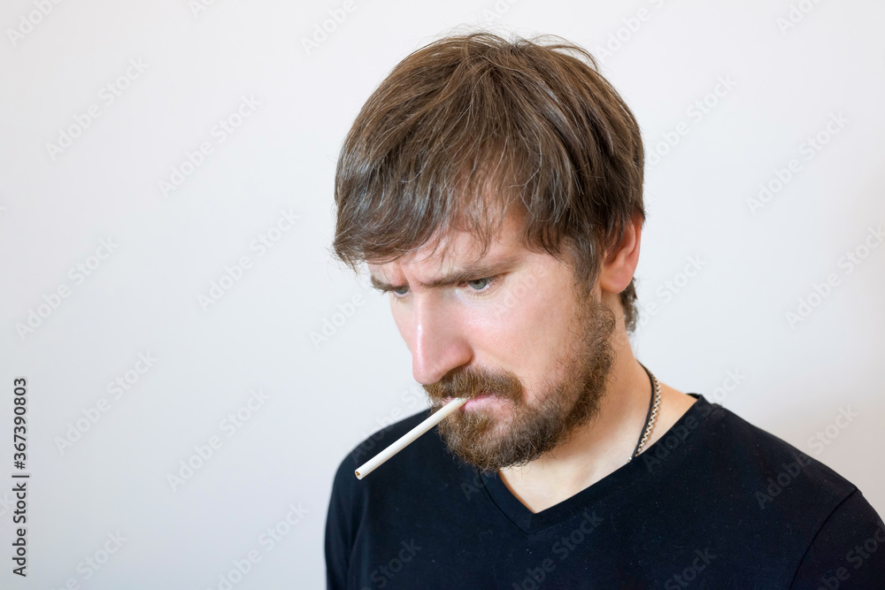 Portrait of a man with a cigarette in the office of a psychologist. Psychology, psychotherapy, social problems, addiction concept. Portrait of a man with a cigarette in the office of a psychologist. Psychology, psychotherapy, social problems, addiction concept.