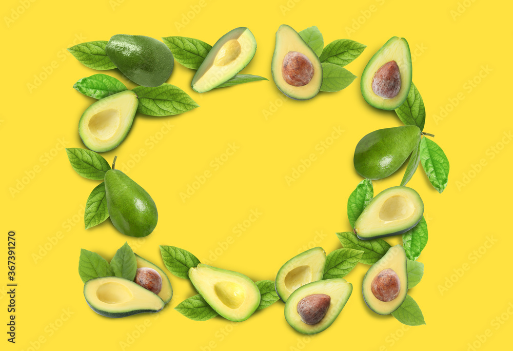 Frame of ripe avocados on yellow background. Space for text Frame of ripe avocados on yellow background. Space for text