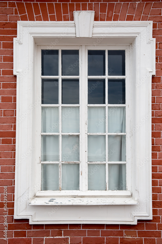 Window on the red brick wall old building