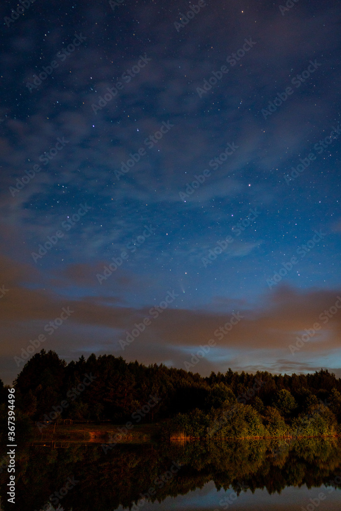 Evening landscape: first stars and a comet Neowise over a forest lake just after sunset. Long exposure night landscape. Evening landscape: first stars and a comet Neowise over a forest lake just after sunset. Long exposure night landscape.