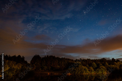 Evening landscape  first stars and a comet Neowise over a forest lake just after sunset. Long exposure night landscape. 