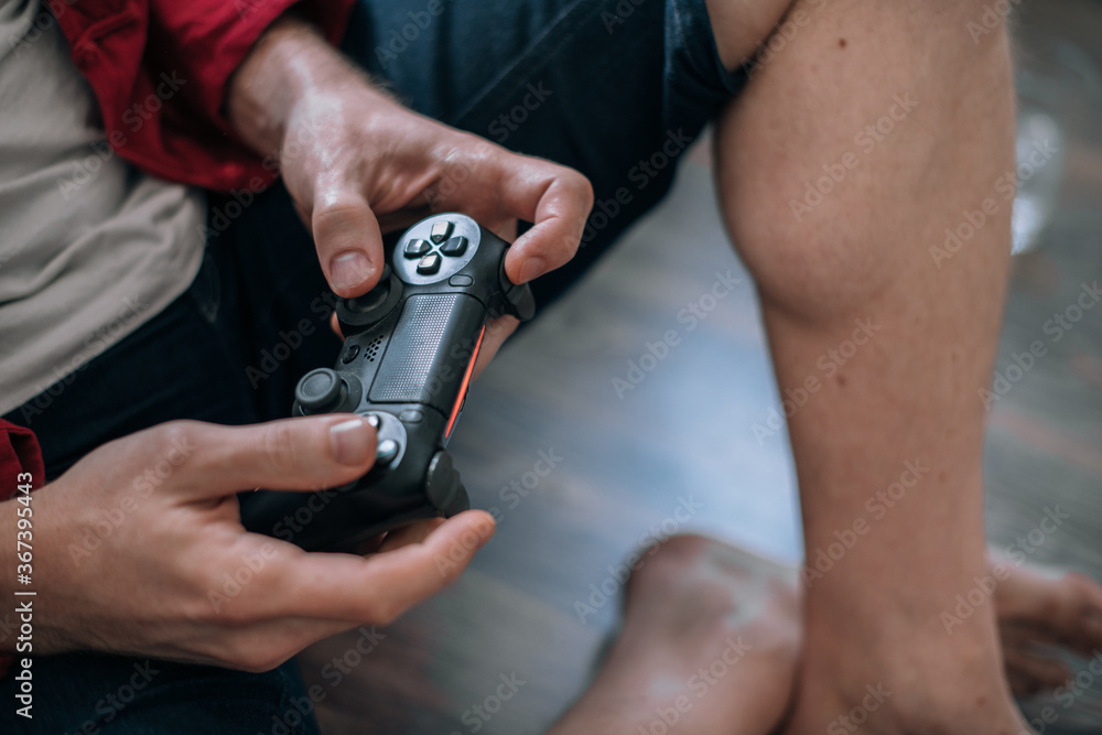 Close-up of male hands with a joystick