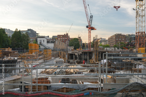 Panoramic View of Urban Construction Site with cranes and building material