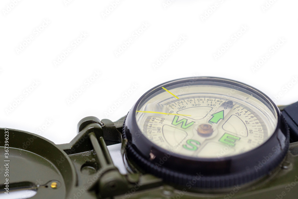 Closeup green color military compass on isolated white background. Closeup green color military compass on isolated white background.