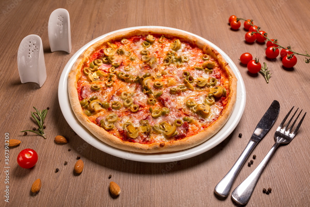Capricciosa pizza thin cake, tomato sauce, ham, olives, marinated mushrooms mozzarella basil Capricciosa pizza thin cake, tomato sauce, ham, olives, marinated mushrooms mozzarella basil