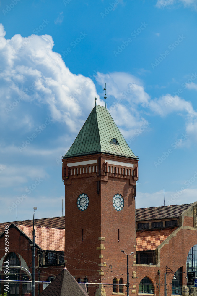 A photo of an old building in Wroclaw, a large, tall clock tower made of bricks.