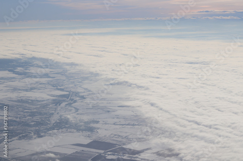 white clouds on the ground covered with snow  blue sky  winter