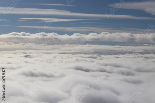 beautiful white clouds on blue sky, view from airplane window