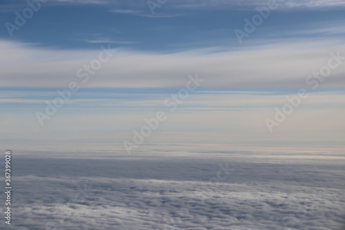 beautiful white clouds on blue sky, view from airplane window
