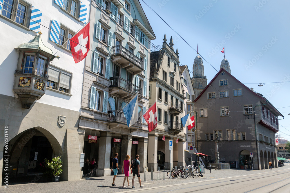 Naklejka premium A view of historic city center of Zurich with Swiss flags, Switzerland
