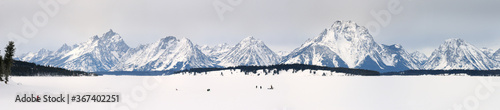 Panorama of Ice fishing on Jackson Lake with Grand Teton peaks and Mount Moran Wyoming photo
