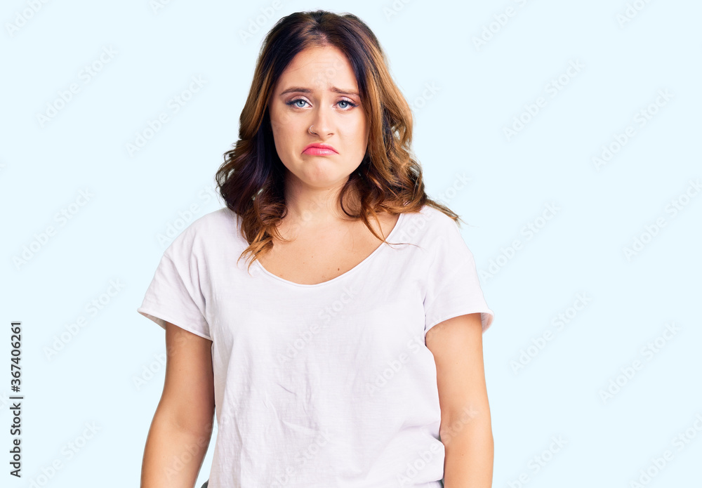 Young beautiful caucasian woman wearing casual white tshirt depressed and worry for distress, crying angry and afraid. sad expression. Young beautiful caucasian woman wearing casual white tshirt depressed and worry for distress, crying angry and afraid. sad expression.