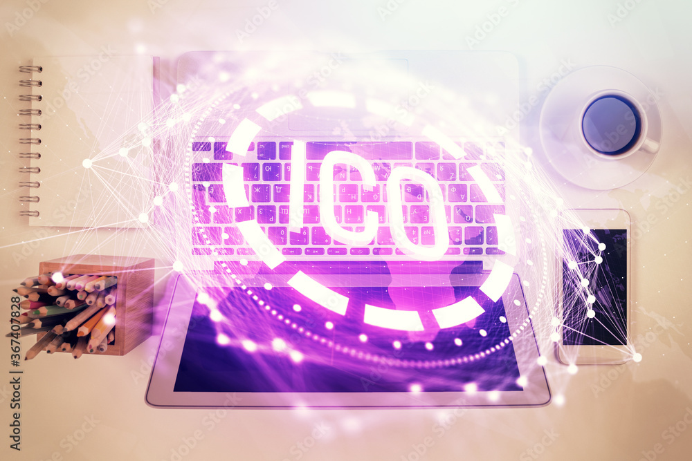 Blockchain theme hologram drawings over computer on the desktop background. Top view. Double exposure. Blockchain theme hologram drawings over computer on the desktop background. Top view. Double exposure.