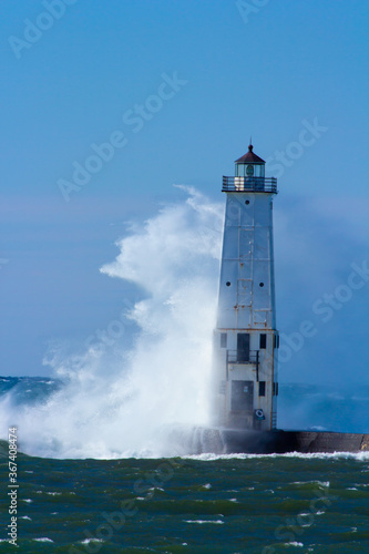 Crashing Wave Against A Lighthouse