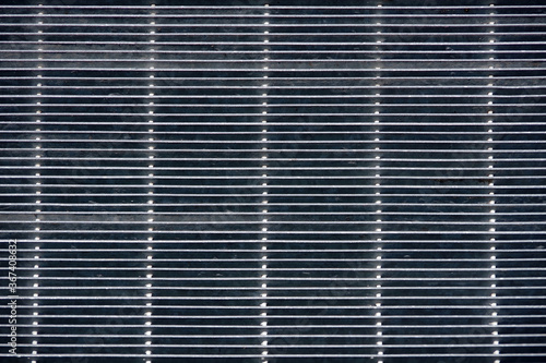 High angle view from top of a part of a metal grate floor of a long foot bridge