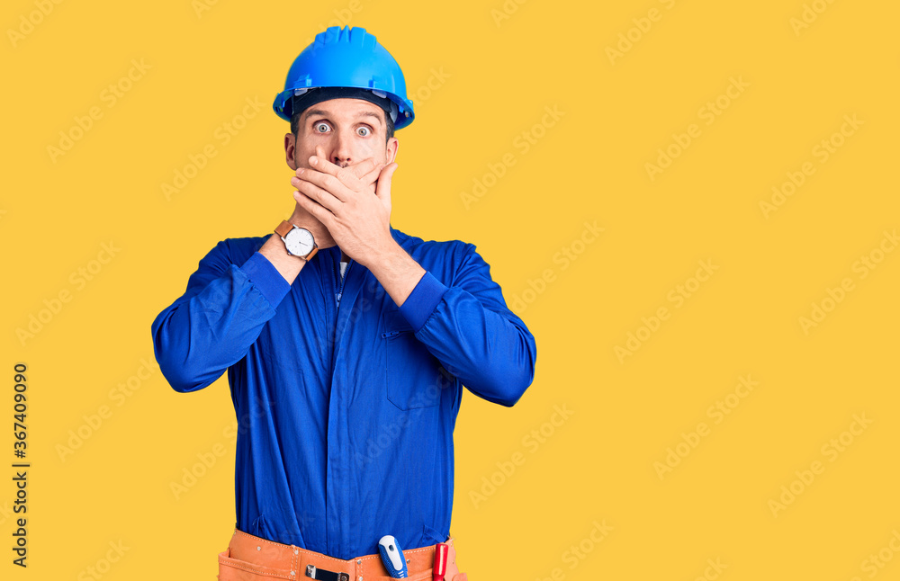Young handsome man wearing worker uniform and hardhat feeling unwell and coughing as symptom for cold or bronchitis. health care concept. Young handsome man wearing worker uniform and hardhat feeling unwell and coughing as symptom for cold or bronchitis. health care concept.