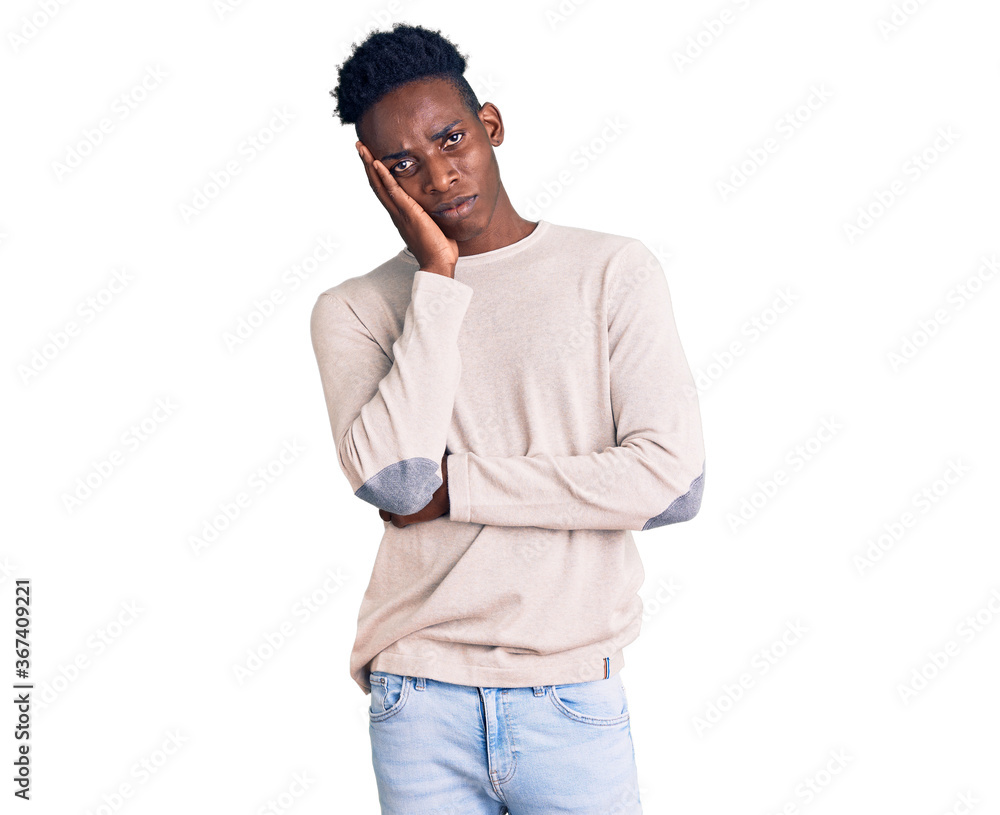 Young african american man wearing casual clothes thinking looking tired and bored with depression problems with crossed arms. Young african american man wearing casual clothes thinking looking tired and bored with depression problems with crossed arms.