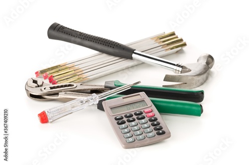 Hammer, gaspipe pliers, screwdriver and calculator on white, home renovation, craftsman cost or building expense concept photo