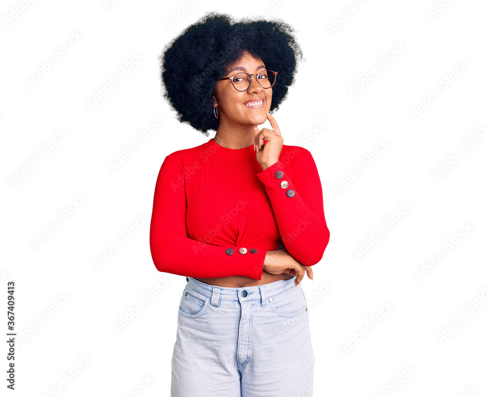 Young african american girl wearing casual clothes and glasses looking confident at the camera smiling with crossed arms and hand raised on chin. thinking positive. Young african american girl wearing casual clothes and glasses looking confident at the camera smiling with crossed arms and hand raised on chin. thinking positive.