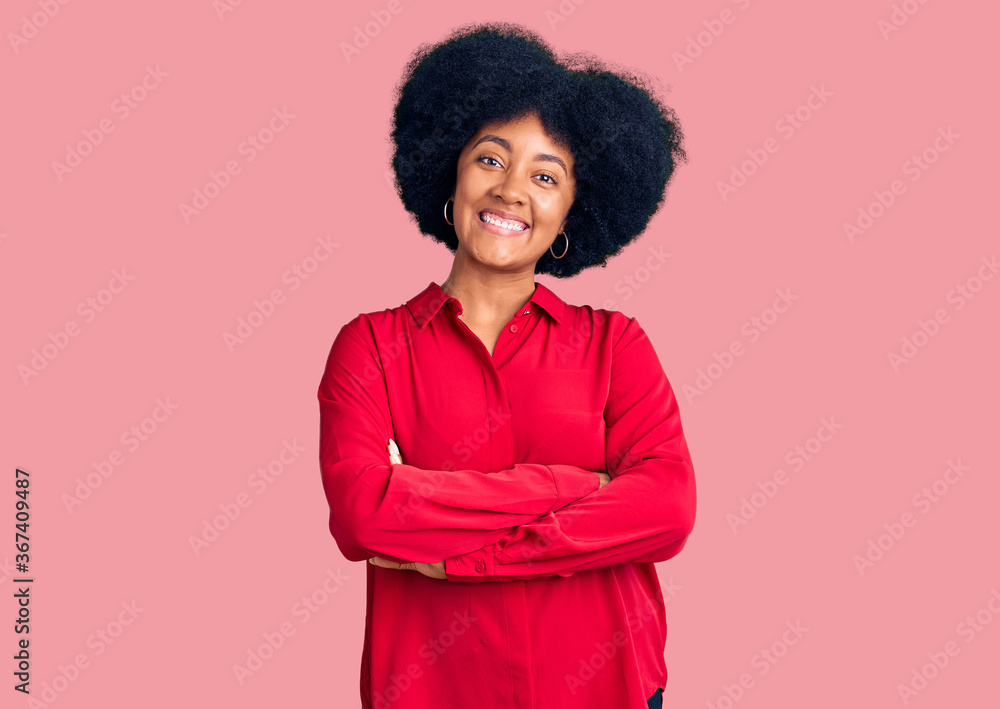 Young african american girl wearing casual clothes happy face smiling with crossed arms looking at the camera. positive person. Young african american girl wearing casual clothes happy face smiling with crossed arms looking at the camera. positive person.