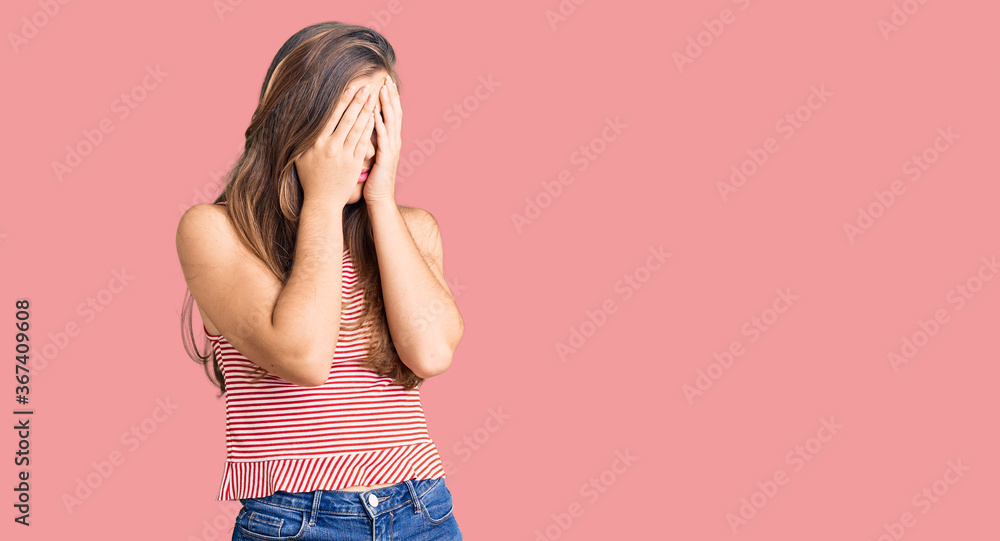 Beautiful caucasian young woman wearing casual clothes with sad expression covering face with hands while crying. depression concept. Beautiful caucasian young woman wearing casual clothes with sad expression covering face with hands while crying. depression concept.