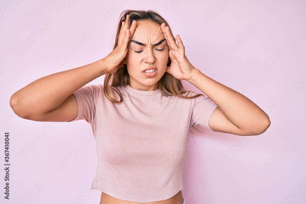 Young beautiful blonde woman wearing casual clothes suffering from headache desperate and stressed because pain and migraine. hands on head. Young beautiful blonde woman wearing casual clothes suffering from headache desperate and stressed because pain and migraine. hands on head.