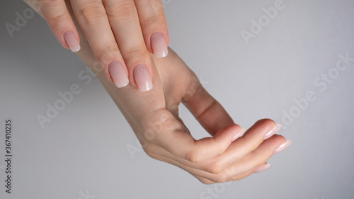 beautiful hands with manicured nude nails manicure