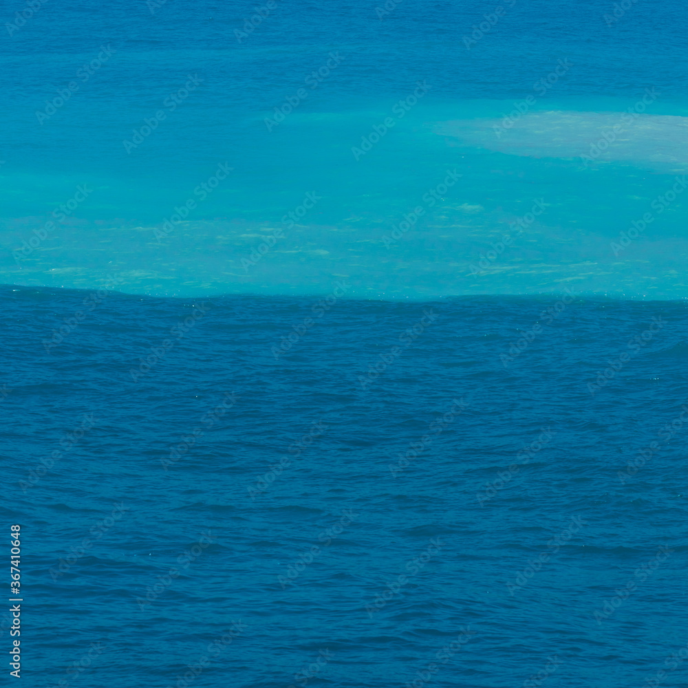 an amazing view of the sea split in two colors blue and turquiose 