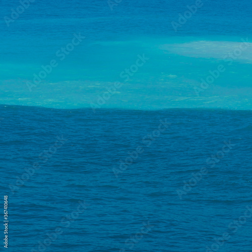 an amazing view of the sea split in two colors blue and turquiose 